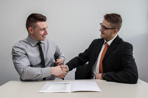 Smiling Men Shaking Hands