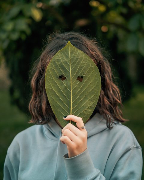 Person Hiding Behind Mask