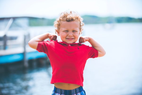 Kid Making Muscles