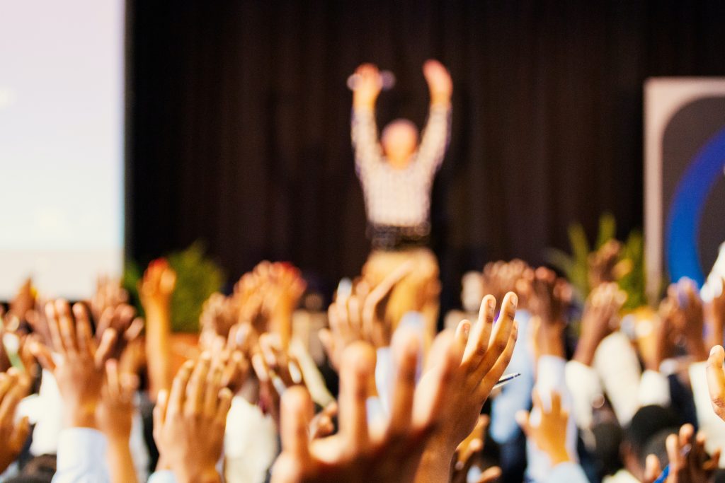 Arms Raised In Front Of Audience