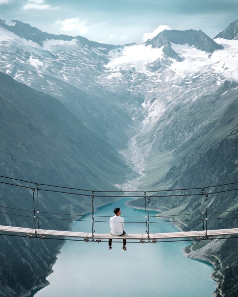 Man Sitting On Bridge