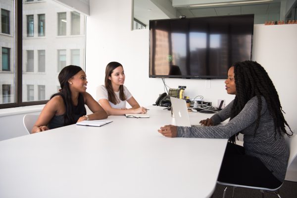 3 Women Talking At Conference Table