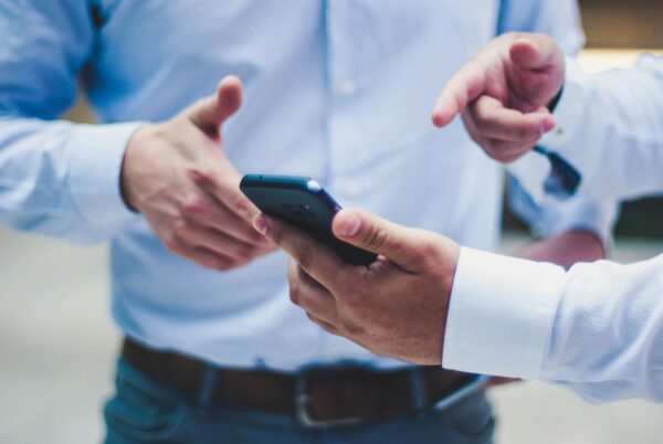 Man pointing at cell phone